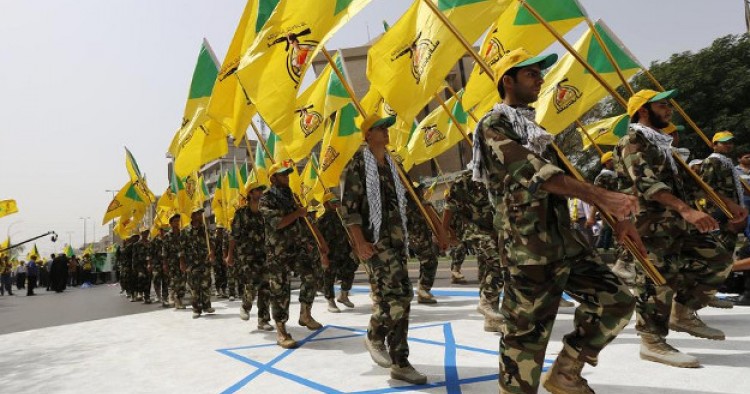 Iraqi Hezbollah soldiers marching with flags