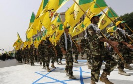 Iraqi Hezbollah soldiers marching with flags