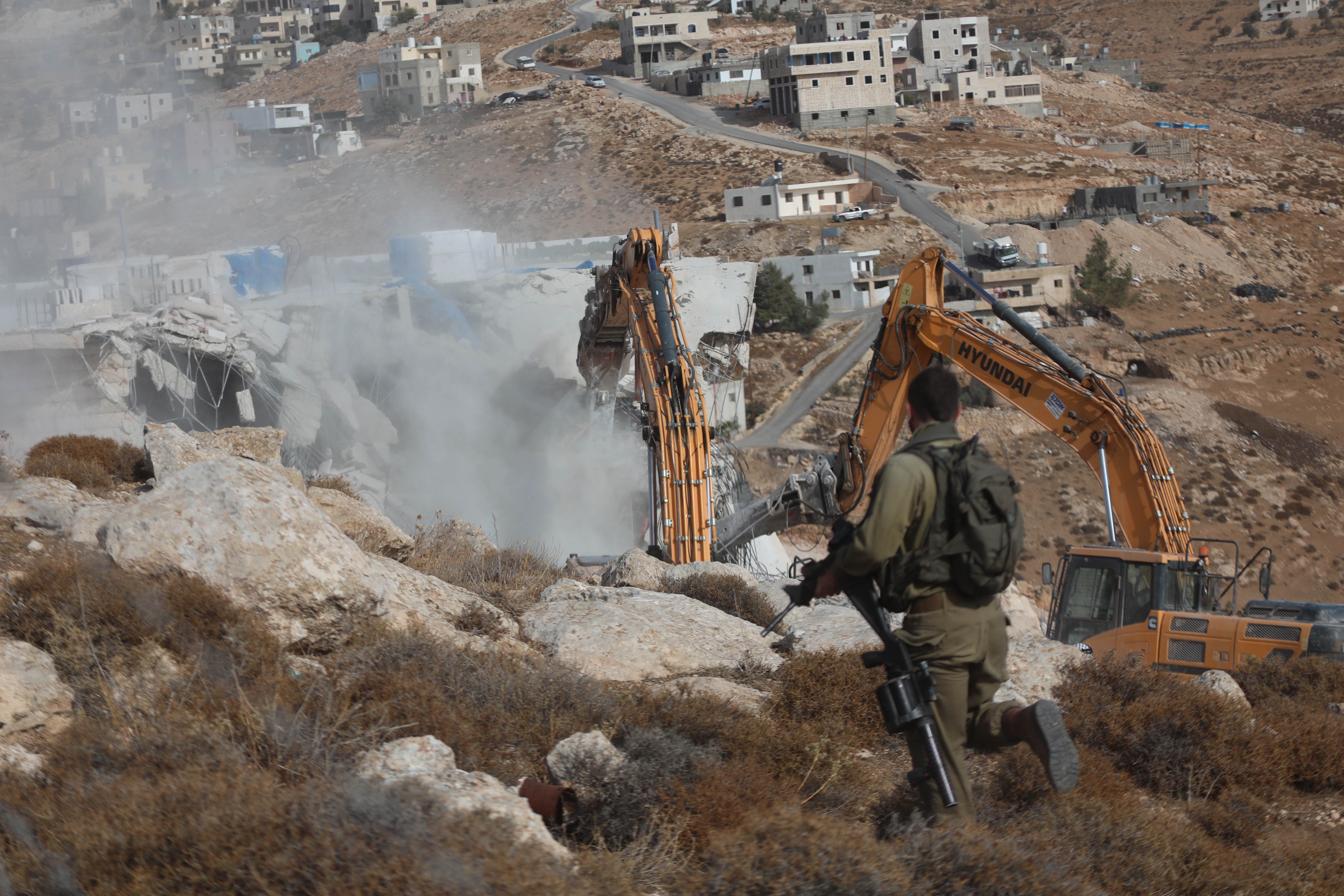 MIDEAST-HEBRON-HOUSE-DEMOLITION  Israeli bulldozers demolish a Palestinian house, which is believed to have been built without permit, in Bani Naim town near the West Bank city of Hebron, Oct. 25, 2022. (Photo by Mamoun Wazwaz/Xinhua via Getty Images)