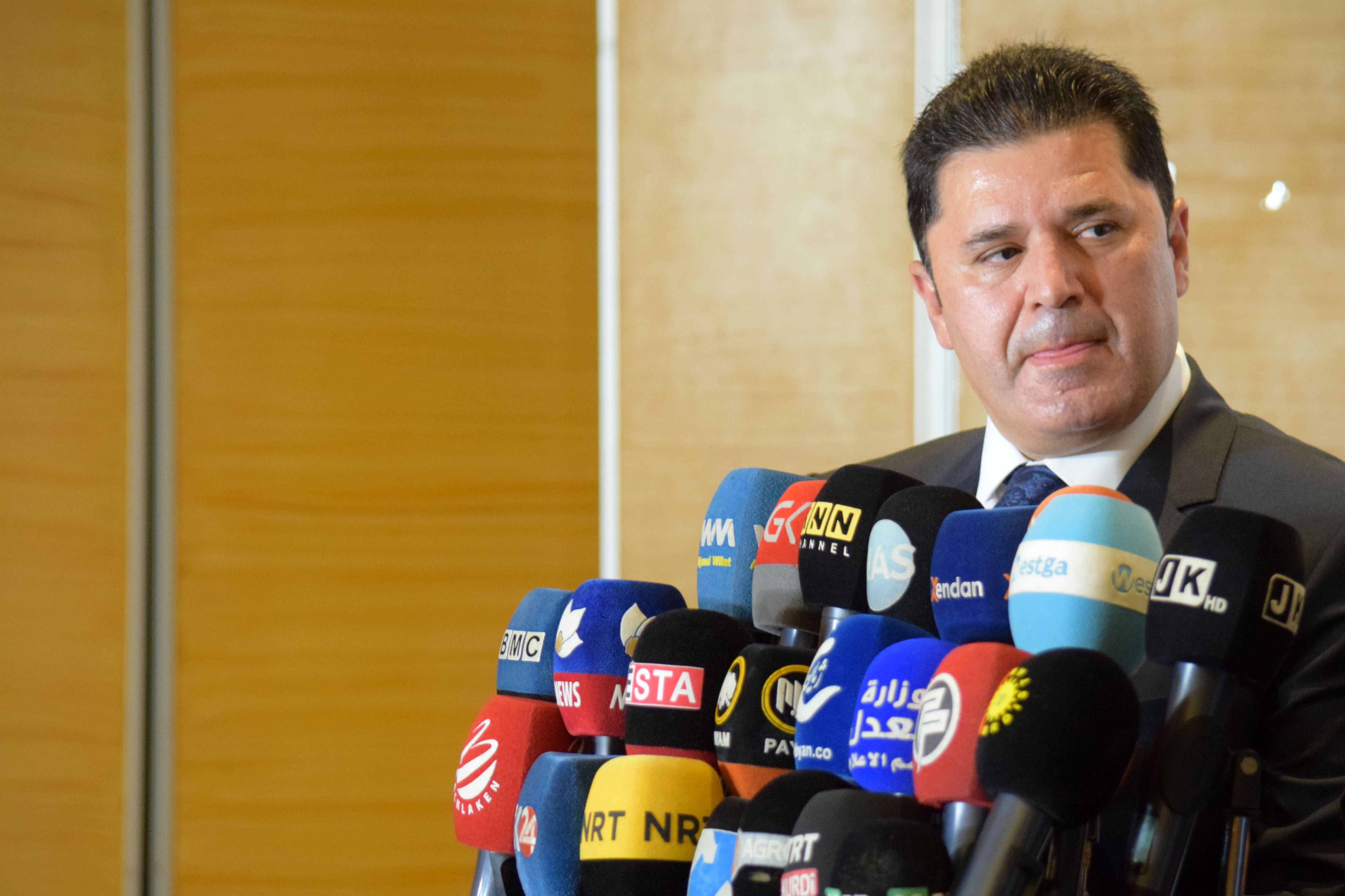 KRG Coordinator for International Advocacy Dindar Zebari stands behind microphones of Kurdish media outlets at a press conference in Sulaymaniyah on May 6, 2021. (Photo: Winthrop Rodgers)