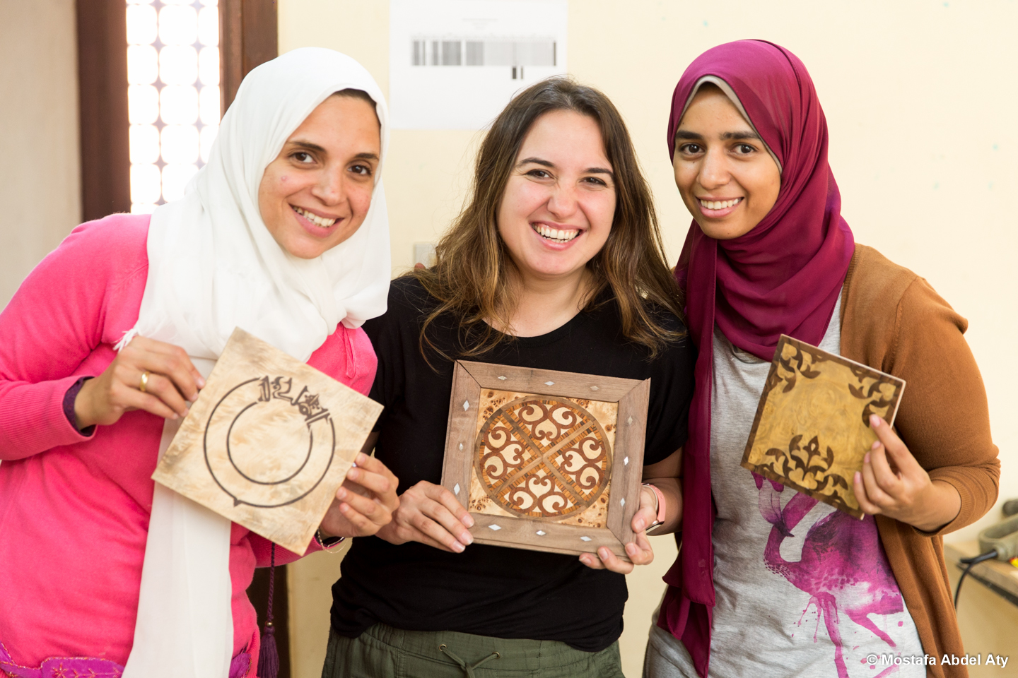 students show off their art pieces at the exhibit