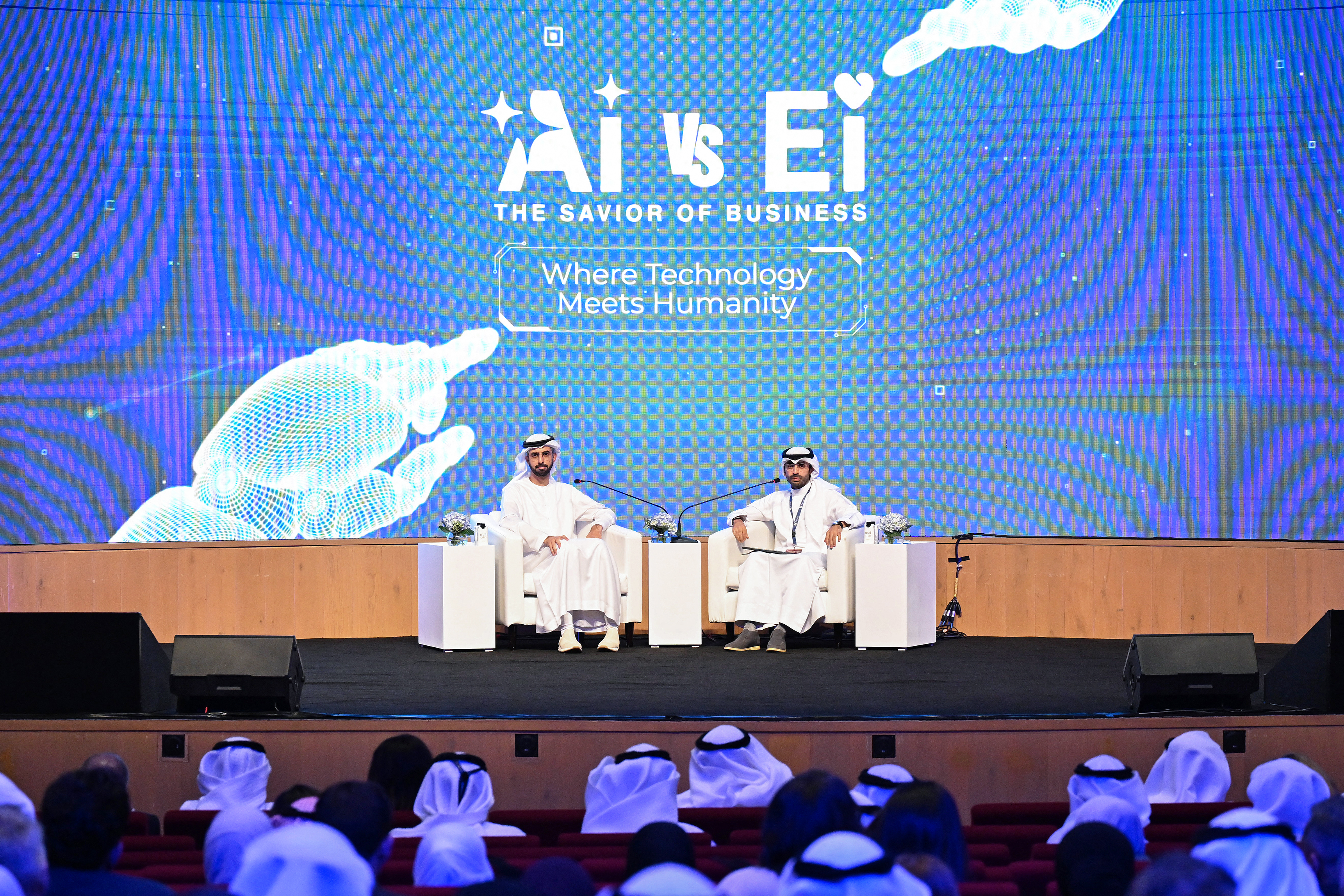 Photo above: Omar al-Olama, the UAE’s minister of state for artificial intelligence, digital economy, and remote work (L), and Kuwait News Managing Director Abdullah Boftain take part in a discussion at the Breaking Barriers 3: AI vs. EI — The Savior of Business conference at the Jaber al-Ahmad Cultural Center in Kuwait City on November 16, 2025. Photo by Yasser al-Zayyat/AFP via Getty Images.