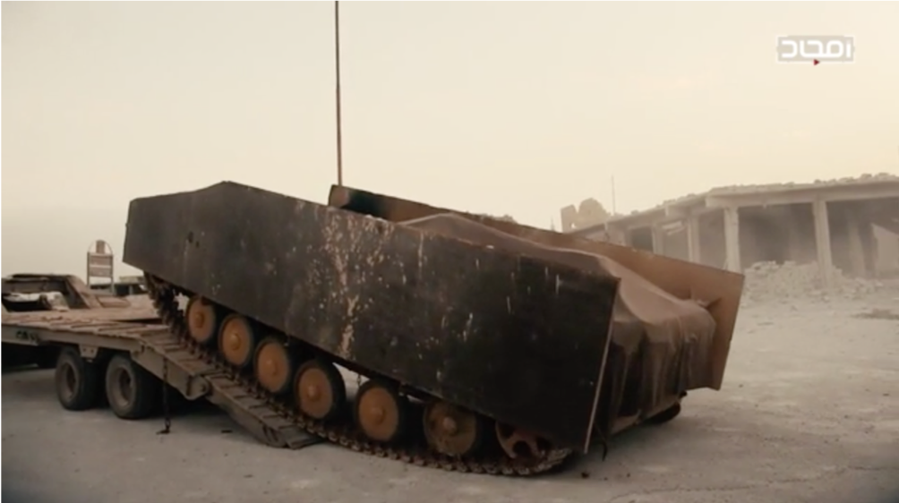 An up-armored BMP-1 SVBIED being unloaded from a transport vehicle, to be used against a Syrian Army position near Abu Duhur airbase in eastern Idlib Province on Jan. 12, 2018.