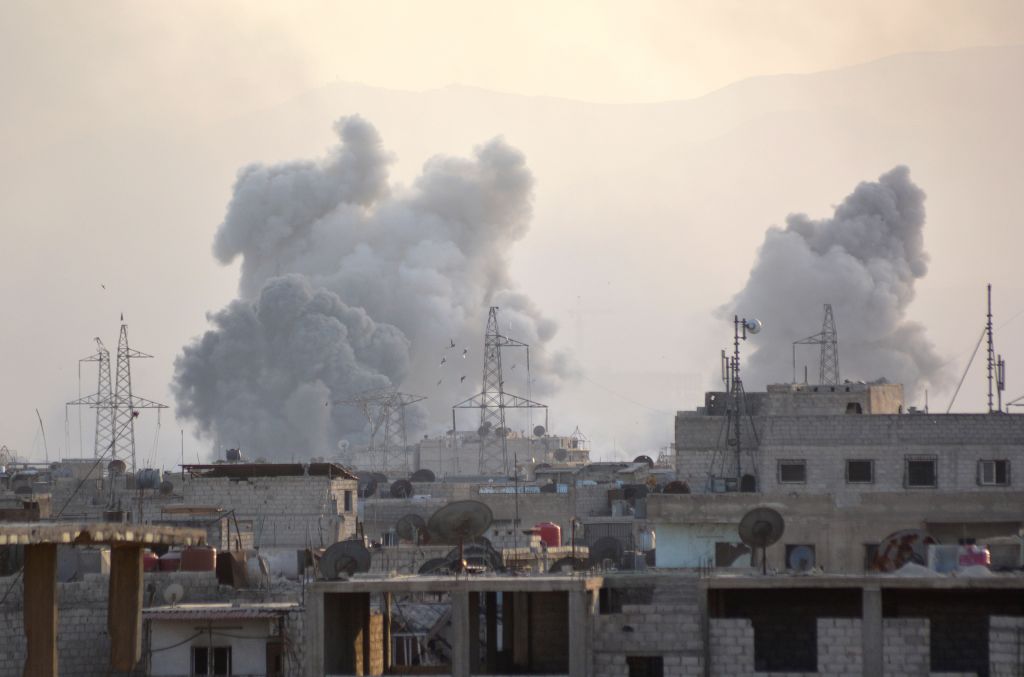 Smoke rises after Assad regime forces carried out airstrikes over the Daesh controlled part of Yarmouk refugee camp where Palestinian refugees take shelter, on the outskirts of Syrias capital Damascus on April 24, 2018. (Photo by Rami Alsayed /Anadolu Agency/Getty Images)