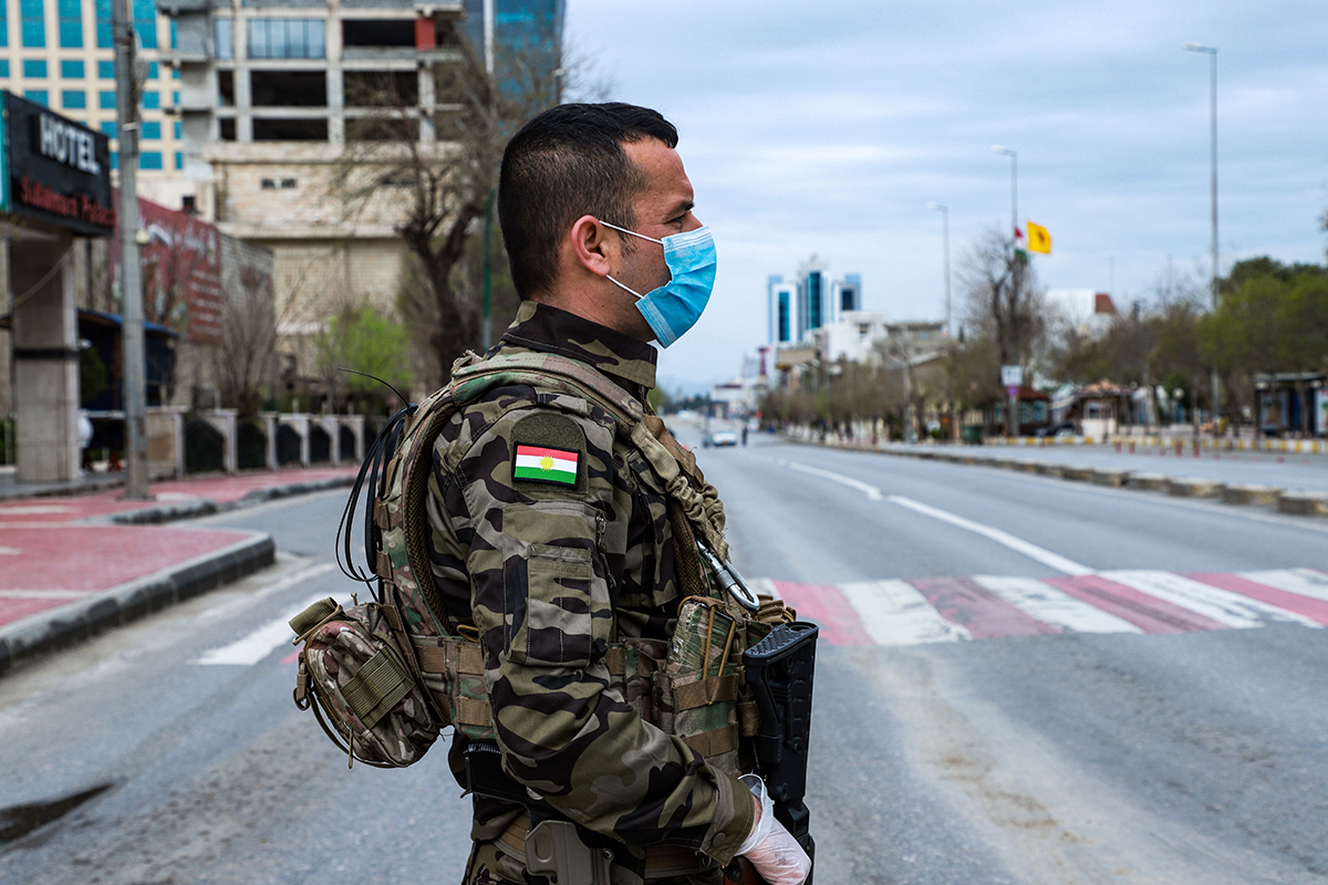 Photo above: A member of the Iraqi Kurdish asayish security organization at a security checkpoint in the city of Sulaimaniyah, on March 14, 2020. Photo by SHWAN MOHAMMED/AFP via Getty Images. 