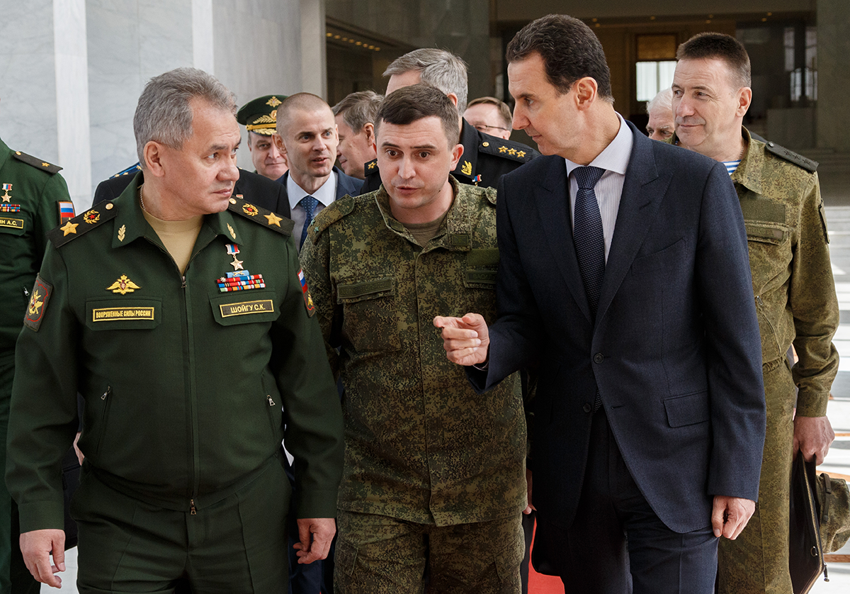 Russia's Defence Minister Sergei Shoigu (L front) and Syria's President Bashar al-Assad (R front) during a meeting. Vadim Savitsky/Russian Defence Ministry Press Office/TASS (Photo by Vadim Savitsky\TASS via Getty Images)