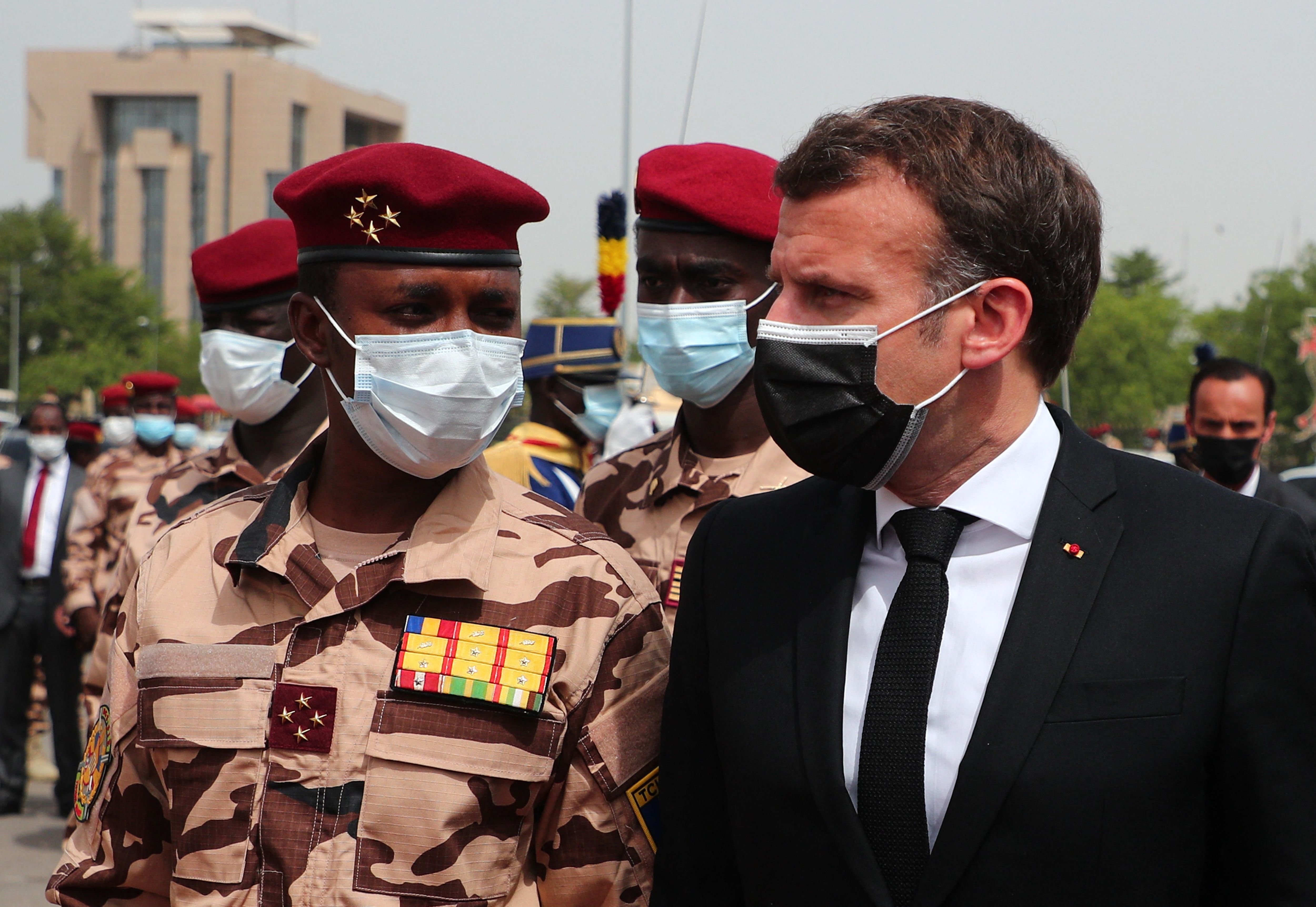 Photo above: French President Emmanuel Macron (C) flanked by the son of the late Chadian President Idriss Deby, Mahamat Idriss Deby (L), arrives to attend the state funeral for Idriss Deby in N’Djamena on April 23, 2021. Photo by CHRISTOPHE PETIT TESSON/POOL/AFP via Getty Images.