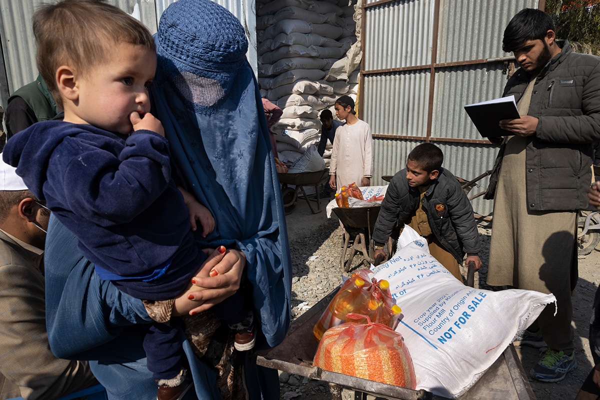 Afghans receive humanitarian aid from the World Food Program on November 6, 2021 in Kabul, Afghanistan. Photo by Paula Bronstein /Getty Images.