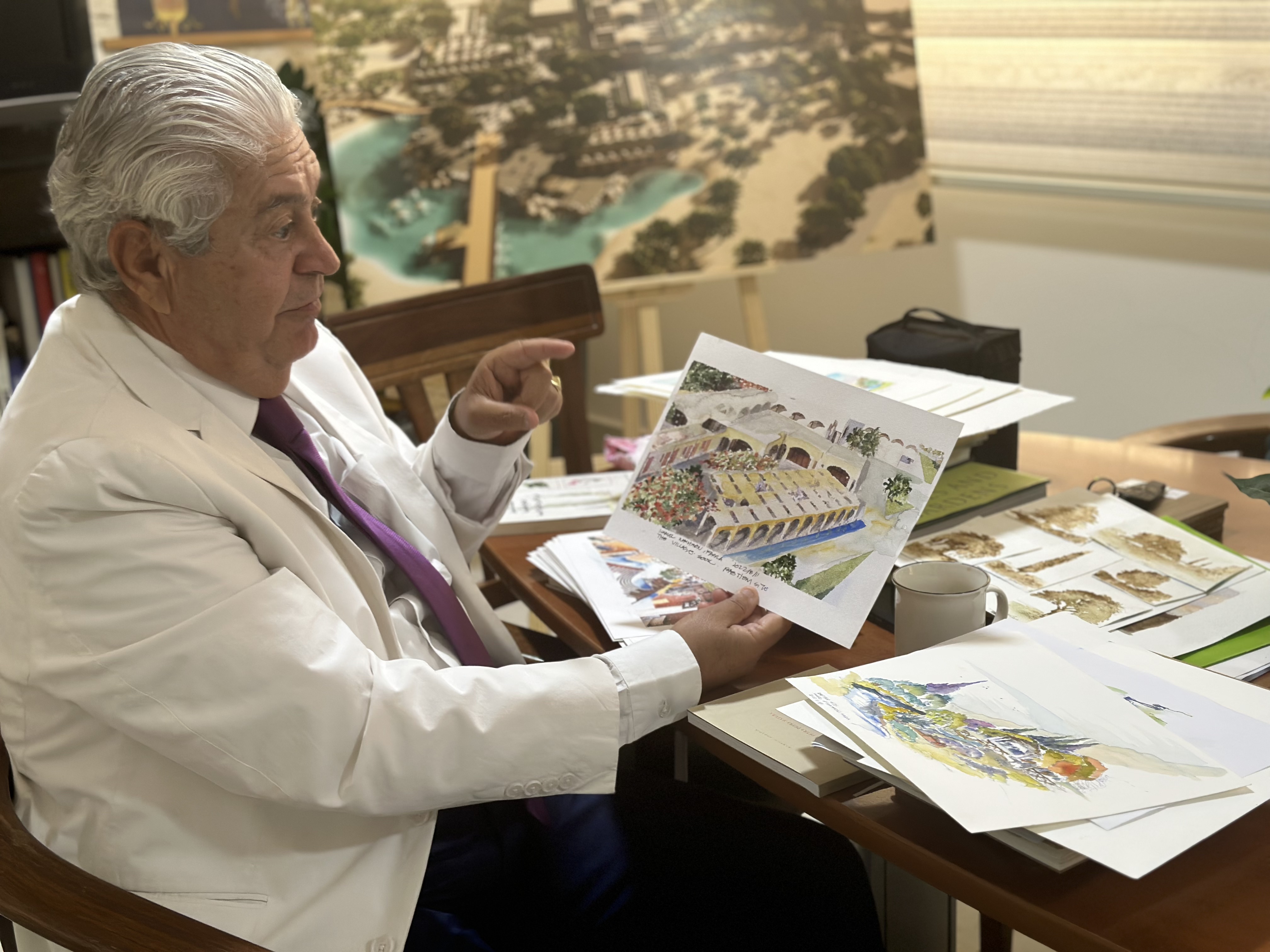 Kamel Mahadin demonstrates his watercolour images with plans for advancing the baptism site.