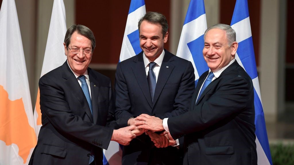 Greek Prime Minister Kyriakos Mitsotakis (C), his Israeli counterpart Benjamin Netanyahu (R) and Cypriot President Nikos Anastasiadis shake hands in Athens on January 2, 2020, ahead of the signing of an agreement for the EastMed pipeline project designed to ship gas from the eastern Mediterranean to Europe. 
