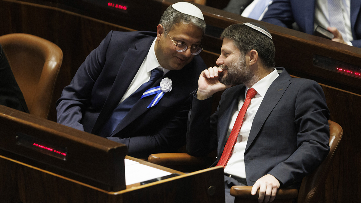 Itamar Ben-Gvir, lawmaker and leader of the Otzma Yehudit party, left, speaks with Bezalel Smotrich, lawmaker and leader of the Religious Zionist party, during a swearing in ceremony at the Knesset on November 15, 2022. Photo by Kobi Wolf/Bloomberg via Getty Images.