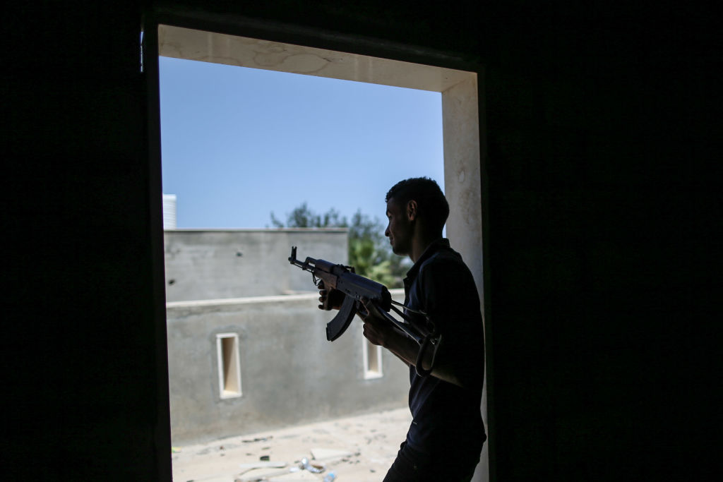  A fighter of Libya's UN-backed Government of National Accord (GNA) of Fayez Serraj, fires his rifle during clashes with forces of the self-styled Libyan National Army (LNA) led by Libyan strongman Khalifa Haftar, at Al-Khalla frontline.