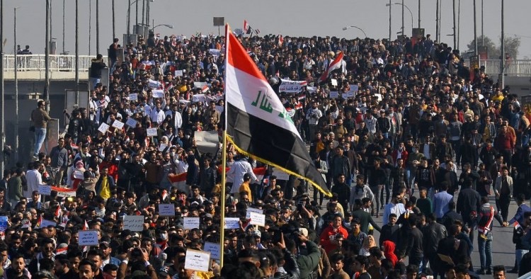 Iraqi students, waving national flags, join anti-government protests in the Shiite shrine city of Najaf in central Iraq on January 28, 2020. (Photo by HAIDAR HAMDANI/AFP via Getty Images)