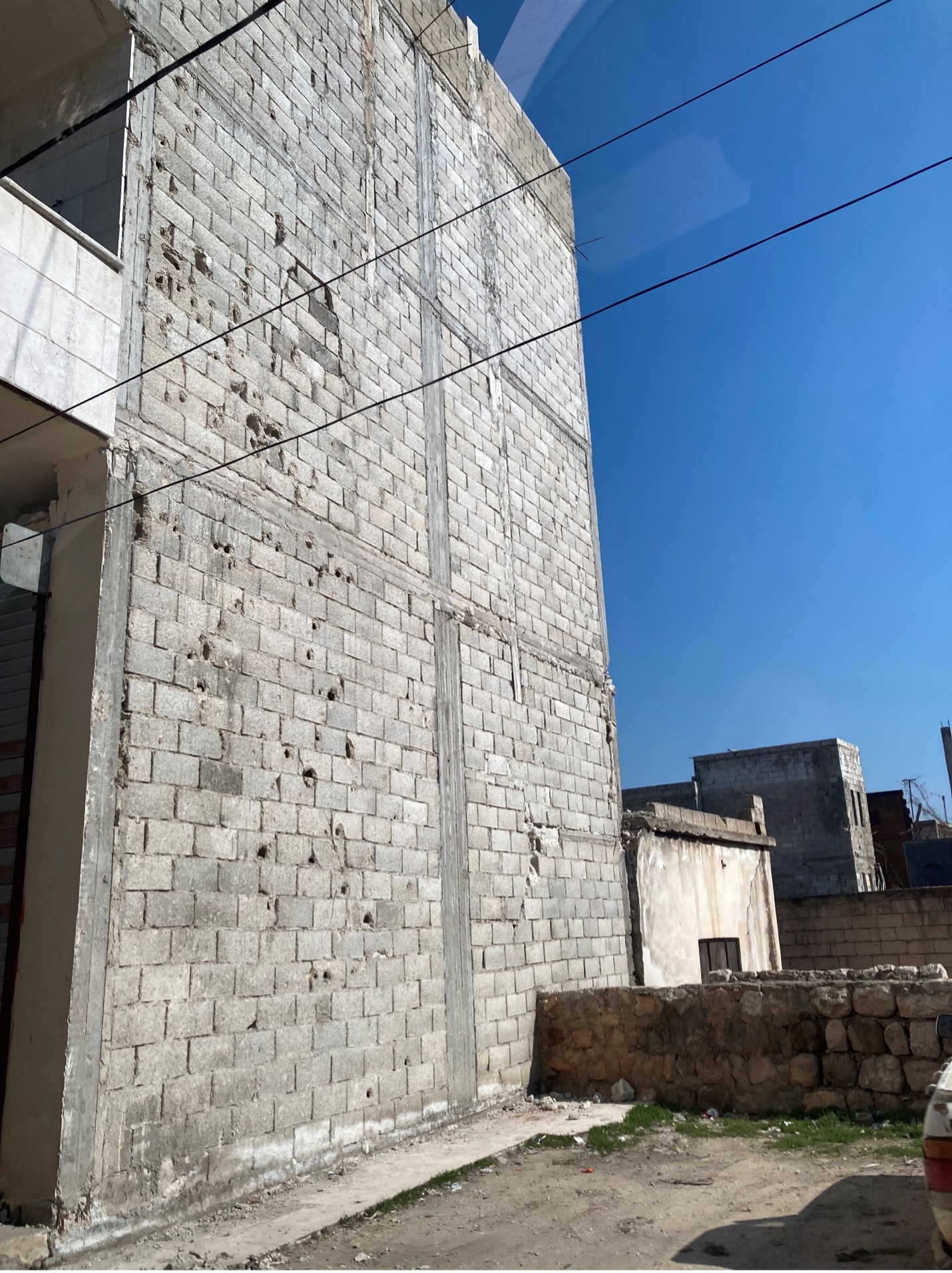 The scars of the war still mark the city of Atareb, the last stop in west Aleppo before regime territory. A key strategic point for many years, the city has endured countless shelling and bombing attacks from the regime and Russian forces, including the destruction of its hospital in 2019. These attacks left many buildings weak and vulnerable to the quake, which knocked some down and destroyed the interiors of many others. 