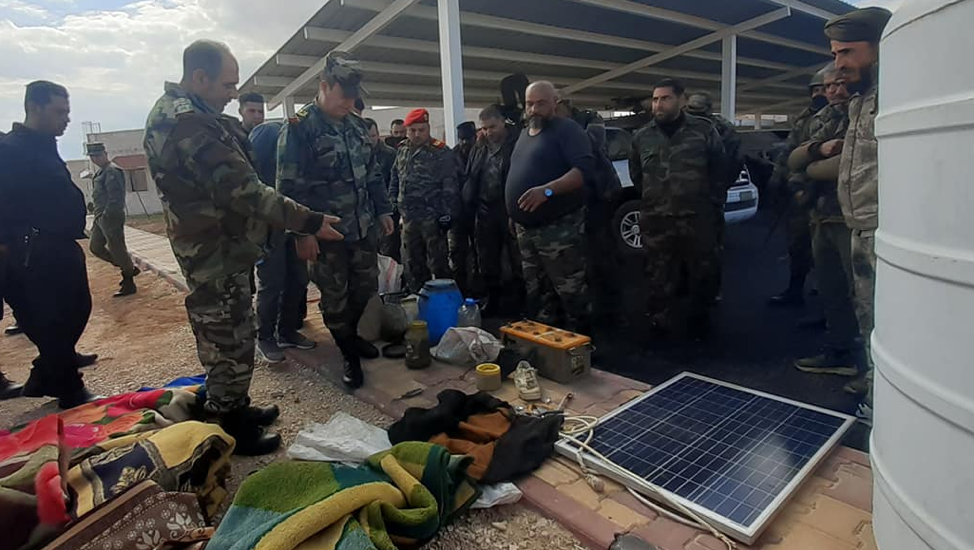 Maj. Gen. Khader examining supplies recovered from an ISIS cache near Mount Bishri.