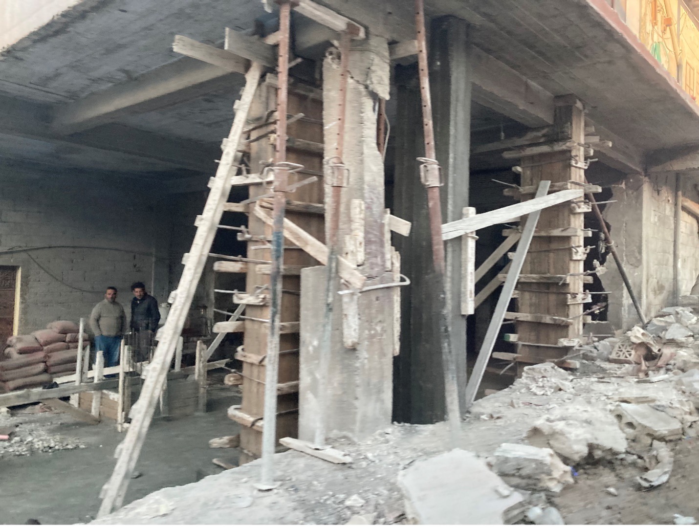 In the remote mountain village of Maland, locals begin repairing the foundations of a multi-story unit.