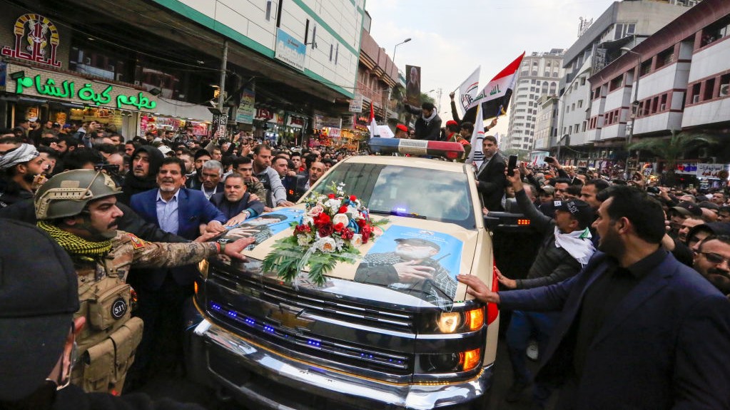 Mourners surround a car carrying the coffins of Iranian military commander Qasem Soleimani and Iraqi paramilitary chief Abu Mahdi al-Muhandis, killed in a US air strike, during their funeral procession in Kadhimiya, a Shiite pilgrimage district of Baghdad, on January 4, 2020. 