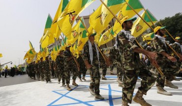 Iraqi Hezbollah soldiers marching with flags