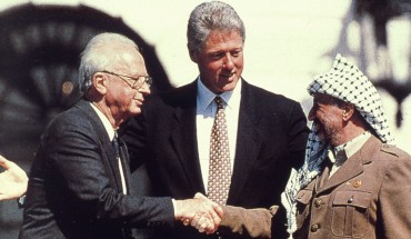 Clinton observing handshake