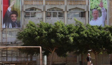 Posters of Hezbollah Shiite movement's leader Hassan Nasrallah (L) and of ex-army chief and leader of the Free Patriotic Movement party Michel Aoun, are seen in Aoun's hometown of Haret Hreik, a southern Beirut suburb, on October 31, 2016.