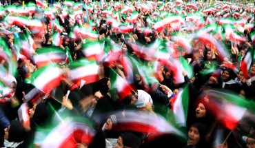 Iranian schoolgirls wave their national flag during celebrations in Tehran's Azadi Square (Freedom Square) to mark the 37th anniversary of the Islamic revolution on February 11, 2016.
