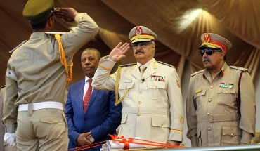 Libyan Strongman Khalifa Haftar salutes next to Libyan National Army's Chief Of Staff Abdelrazak al-Nadhuri and Libyan former prime minister Abdullah al-Thani.