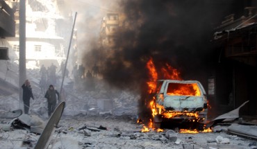 Firefighters extinguish a fire after ISIS terrorists’ car-bomb attack against Ahrar ash-Sham Headquarters in Aleppo, Syria on January 25, 2016. 