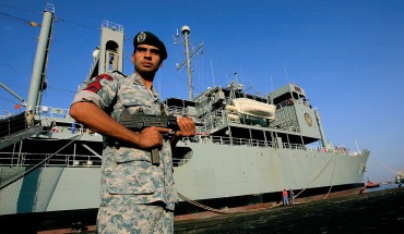 An Iranian navy special forces known as Takavaran wearing a similar uniform worn by the US military and holding an Israeli made Uzi sub-machine gun stands guard near the Iranian Kharg replenishment ship docked in the Red Sea Sudanese town of Port Sudan on October 31, 2012. 