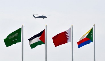 a helicopter flying over flags at the Ithra center during the 29th Summit of the Arab League in Dhahran in Eastern Province, Saudi Arabia on April 15, 2018.