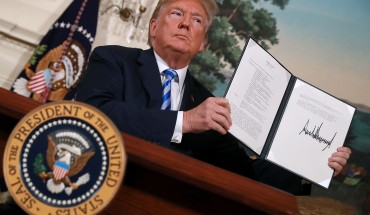 WASHINGTON, DC - MAY 08: U.S. President Donald Trump holds up a memorandum that reinstates sanctions on Iran after he announced his decision to withdraw the United States from the 2015 Iran nuclear deal in the Diplomatic Room at the White House May 8, 2018 in Washington, DC. After two and a half years of negotiations, Iran agreed in 2015 to end its nuclear program in exchange for Western countries, including the United States, lifting decades of economic sanctions. Since then international inspectors have n