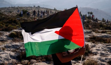 A Palestinian protester waves a Palestinian flag during a demonstration in the village of Ras Karkar west of Ramallah in the occupied West Bank on September 4, 2018. 