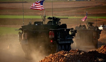 A convoy of US forces armoured vehicles drives near the village of Yalanli, on the western outskirts of the northern Syrian city of Manbij, on March 5, 2017