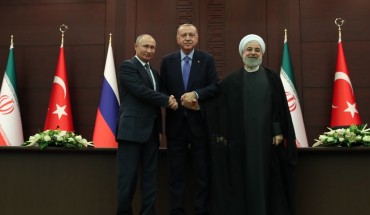 President of Turkey Recep Tayyip Erdogan (C), President of Russia Vladimir Putin (L) and President of Iran Hassan Rouhani (R) shake hands as they pose for a photo after a joint press conference following the Turkey-Russia-Iran trilateral summit at Cankaya Mansion in Ankara, Turkey on September 16, 2019.