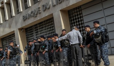 A demonstrator argues with riot police guarding the entrance of the Lebanese Central Bank during a protest by retired Lebanese army and security personnel as part of a preemptive strike against austerity measures in the 2019 draft state budget that might affect their retirement wages. 