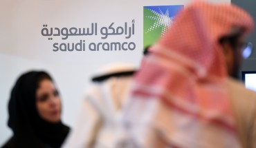 Saudi and Foreign investors stand in front of the logo of Saudi state oil giant Aramco during the 10th Global Competitiveness Forum on January 25, 2016, in the capital Riyadh. The an annual event brings together high-ranking Saudi officials and world business leaders. / AFP / Fayez Nureldine (Photo credit should read FAYEZ NURELDINE/AFP/Getty Images)