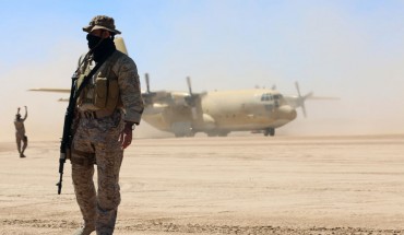 Saudi soldiers stand guard as a Saudi air force cargo plane, carrying aid, lands at an airfield in Yemen's central province of Marib, on February 8, 2018.