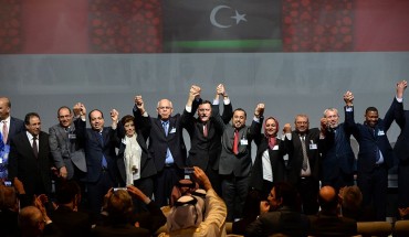 Libya's General National Congress (GNC) deputy president Saleh al-Makhzoum (C-R), the new national government head, Prime Minister, Fayez al-Sarraj (C) and the head of the Tobruk-based House of Representatives Mohammed Ali Shoeb (C-L) celebrate after signing a deal on a unity government on December 17, 2015, in the Moroccan city of Skhirat. 