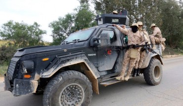 Members of the Tripoli Protection Force, an alliance of militias from the capital city, patrol an area south of the Libyan capital on January 18, 2019, during clashes with the Seventh Brigade group from the town of Tarhuna.