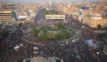 Iraqi demonstrators stand at Tahrir Square in Baghdad during ongoing anti-government demonstrations on October 28, 2019.