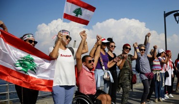 Lebanese people hold hands as they form a human chain, that stretched out along the coast from the capital Beirut to northern and southern Lebanon, symbolizing national unity, on the 11th day of anti-government protests across Lebanon. 