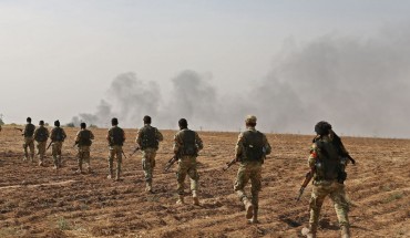 Pro-Turkish Syrian fighters cross the border into Syria as they take part in an offensive against Kurdish-controlled areas in northeastern Syria launched by the Turkish military, on October 11, 2019.