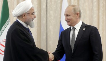 Iran's President Hassan Rouhani (L) and Russia's President Vladimir Putin shake hands as they meet on the sidelines of a meeting of the Shanghai Cooperation Organisation (SCO) Council of Heads of State.