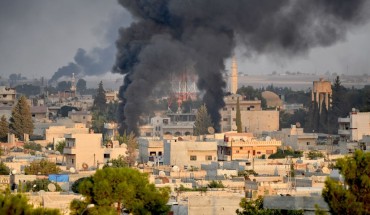 A photo taken from Turkey's Sanliurfa province, on October 09, 2019 shows smoke rises at the site of Ras al-Ayn city of Syria as Turkish troops along with the Syrian National Army begin Operation Peace Spring in northern Syria against PKK/YPG, Daesh terrorists. 