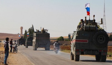 A convoy of Russian military vehicles drives toward the northeastern Syrian city of Kobane on October 23, 2019.