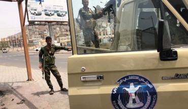 A fighter of the UAE-trained Security Belt Force, dominated by backers of the the Southern Transitional Council (STC) which seeks independence for south Yemen, mans the turret of a technical (pickup truck mounted with an anti-aircraft gun) displaying portraits of separatist leader Aidarus al-Zubaidi and showing the logo of the STC, in the Crater district in the centre of Yemen's second city of Aden on August 12, 2019.