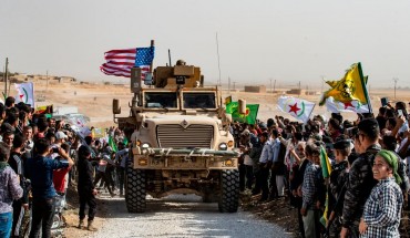  Syrian Kurds gather around a US armoured vehicle during a demonstration against Turkish threats next to a US-led international coalition base on the outskirts of Ras al-Ain town in Syria's Hasakeh province near the Turkish border on October 6, 2019. 