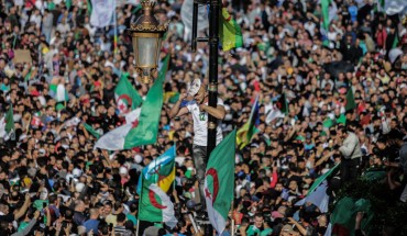 Algerians take part in an anti-government demonstration demanding the ouster of officials who served under ex-president Abdelaziz Bouteflika as they marked the 65th anniversary of the country's fight for independence from France. 