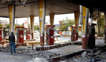 An Iranian man checks a scorched gas station that was set ablaze by protesters during a demonstration against a rise in gasoline prices in Eslamshahr, near the Iranian capital of Tehran, on November 17, 2019. 