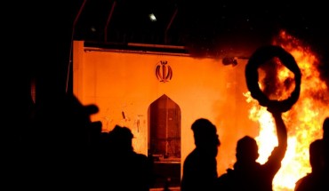 Iraqi demonstrators gather as flames start consuming Iran's consulate in the southern Iraqi Shiite holy city of Najaf on November 27, 2019, two months into the country's most serious social crisis in decades.