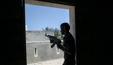 A fighter of Libya's UN-backed Government of National Accord (GNA) of Fayez Serraj, fires his rifle during clashes with forces of the self-styled Libyan National Army (LNA) led by Libyan strongman Khalifa Haftar, at Al-Khalla frontline. 